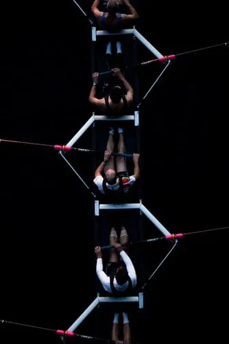 Rowing crew seen from above on dark water